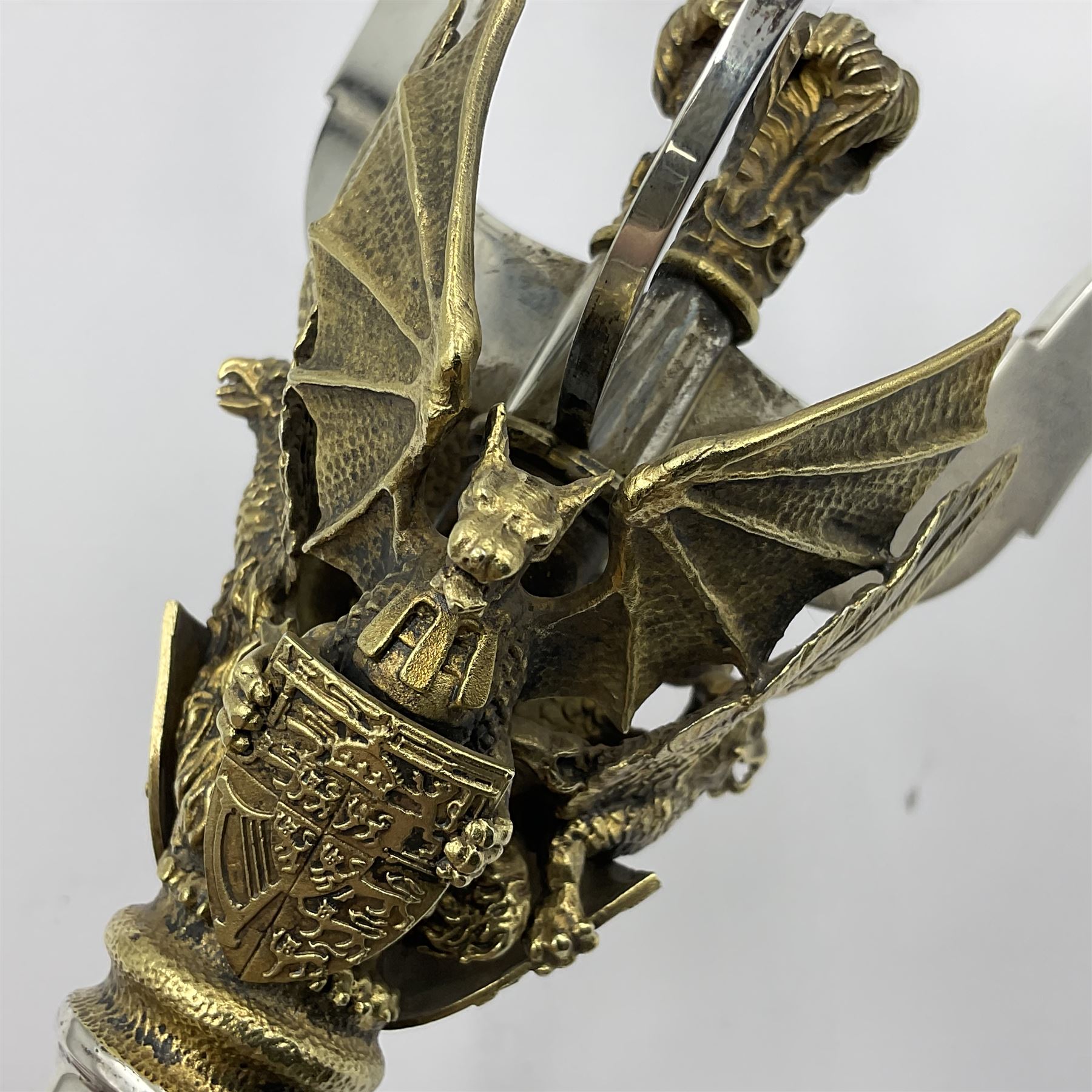 Pair of modern limited edition silver three branch candelabra, commemorating the marriage of HRH Prince Charles and Lady Diana Spencer, replicas of the St Paul's Cathedral candelabra, the three gilt branches each supporting a fluted candle holder and united by a crown containing the Prince of Wales feathers, upon a parcel gilt stem, with three griffins, each holding crested shields, above parcel gilt flower heads cascading to a ciruclar foot, limited edition no. 119 & 120/400, hallmarked Henry Miller for Aurum, London 1981, H22cm
