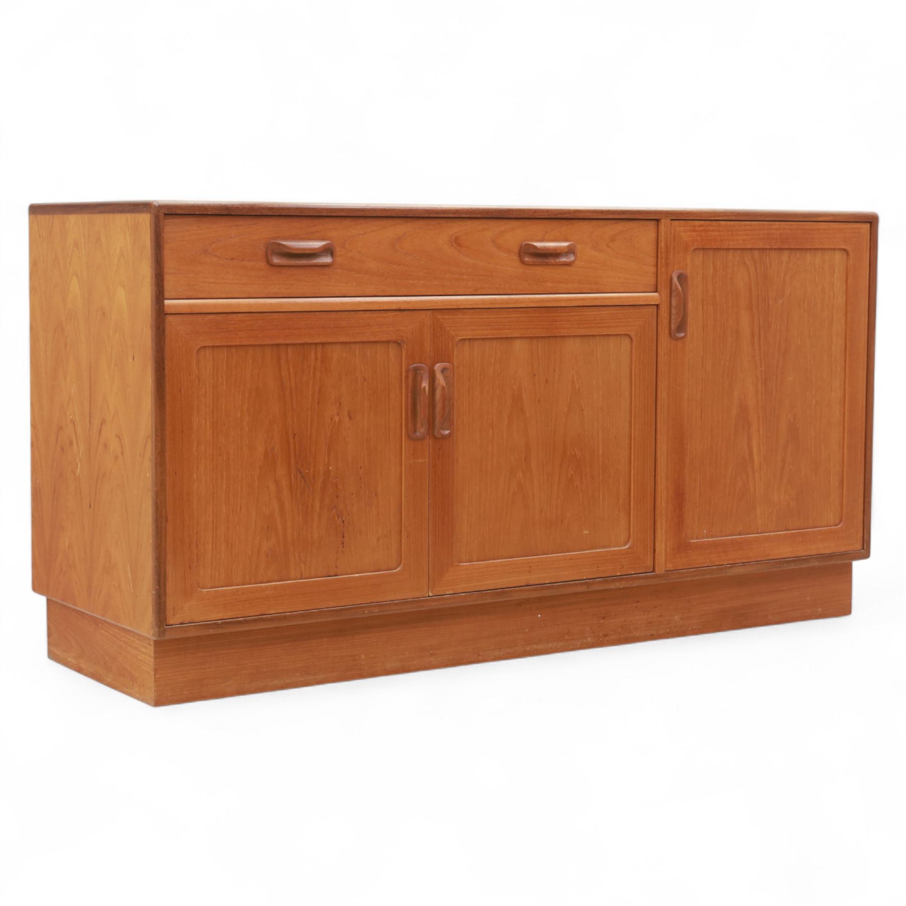 G Plan - Mid-20th century teak sideboard, fitted with single drawer above three cupboard doors, recessed handles throughout, raised on a plinth base