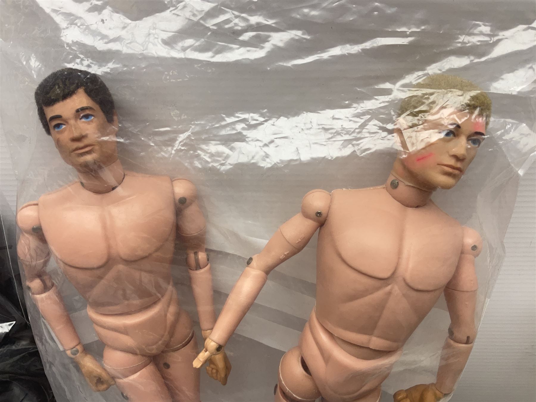Action Man - large collection of 1960s and later figures and accessories including Spaceman with ATLRV vehicle; two figures marked 'Made in England by Palitoy under licence from Hasbro 1964'; twenty-five assorted weapons; radio backpacks; kit bags; twenty-one pairs of boots; football boots and snow shoes; metal diver's boots and three pairs of flippers; two pairs of jackboots; roller skates; various tunics, trousers, flying suits, jumpers, belts etc; twenty helmets, berets, busby, kepis, submariner etc; and quantity of other accessories