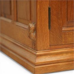  Beaverman - oak media cabinet, rectangular top with interictally carved panels to the side and front doors, twin doors with Yorkshire Rose carved wooden knob, enclosing a staggered shelf arrangement above two drawers, raised on a moulded plinth base, with carved beaver signature, by Colin Almack of Sutton near Thirsk