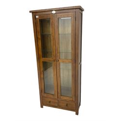 Stained oak display cabinet, fitted with two glazed doors with bevelled plates, over two drawers
