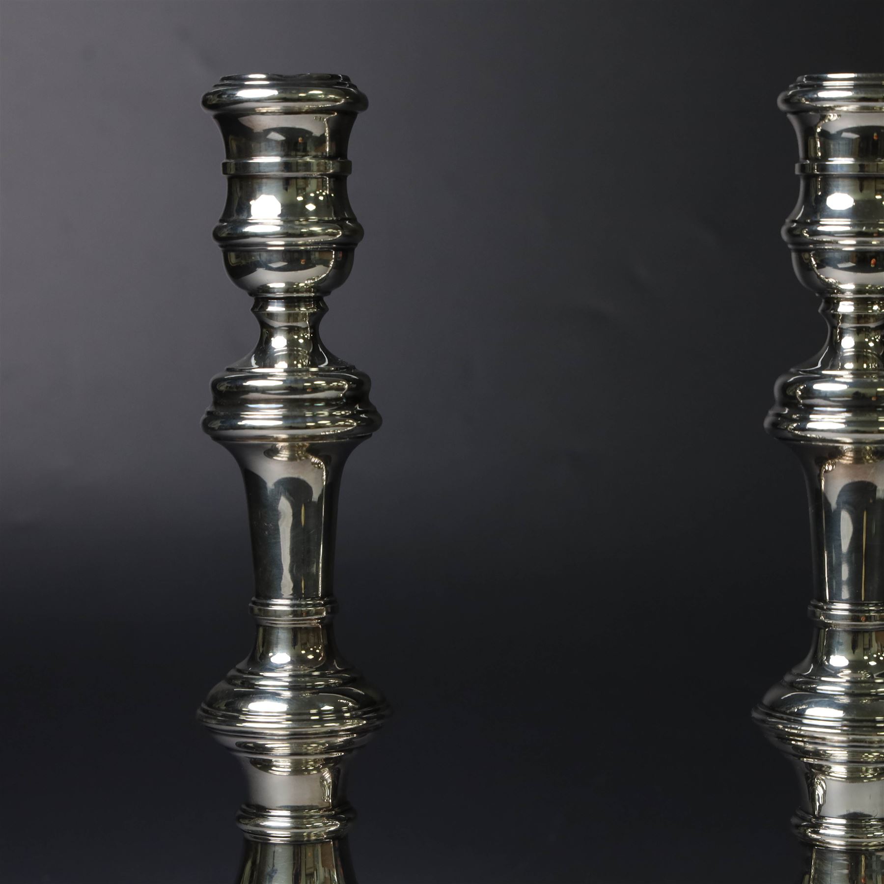 Pair of silver candlesticks, with knopped stems and upon spreading circular weighted bases, hallmarked William Comyns & Sons Ltd, London 1979, H20cm