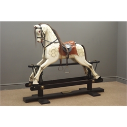  Victorian style wooden rocking horse with white painted and dappled carved sectional body, horsehair mane and tail, padded leather saddle and bridle with brass stirrups and forward and backward action on ebonised refectory style base, bearing plaque 'Special Millenium Limited Edition to mark year 2000 Serial No. 463/500', L150cm H126cm  