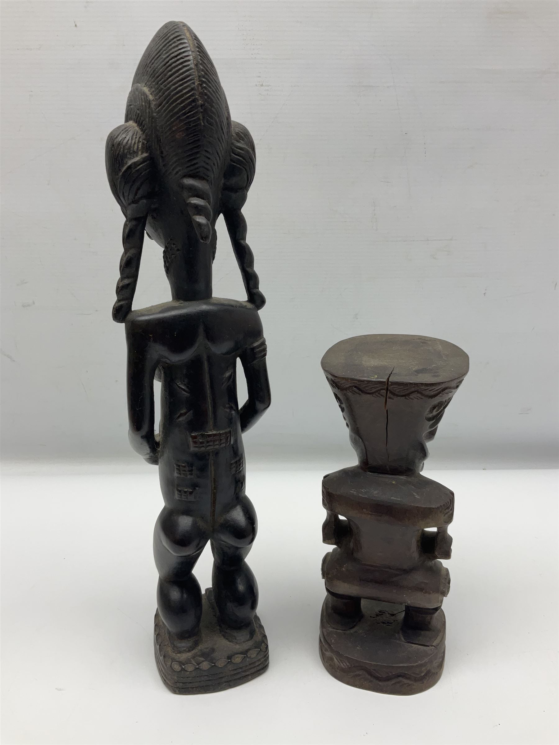Carved african figures, together with a polynesian figure, largest H38cm