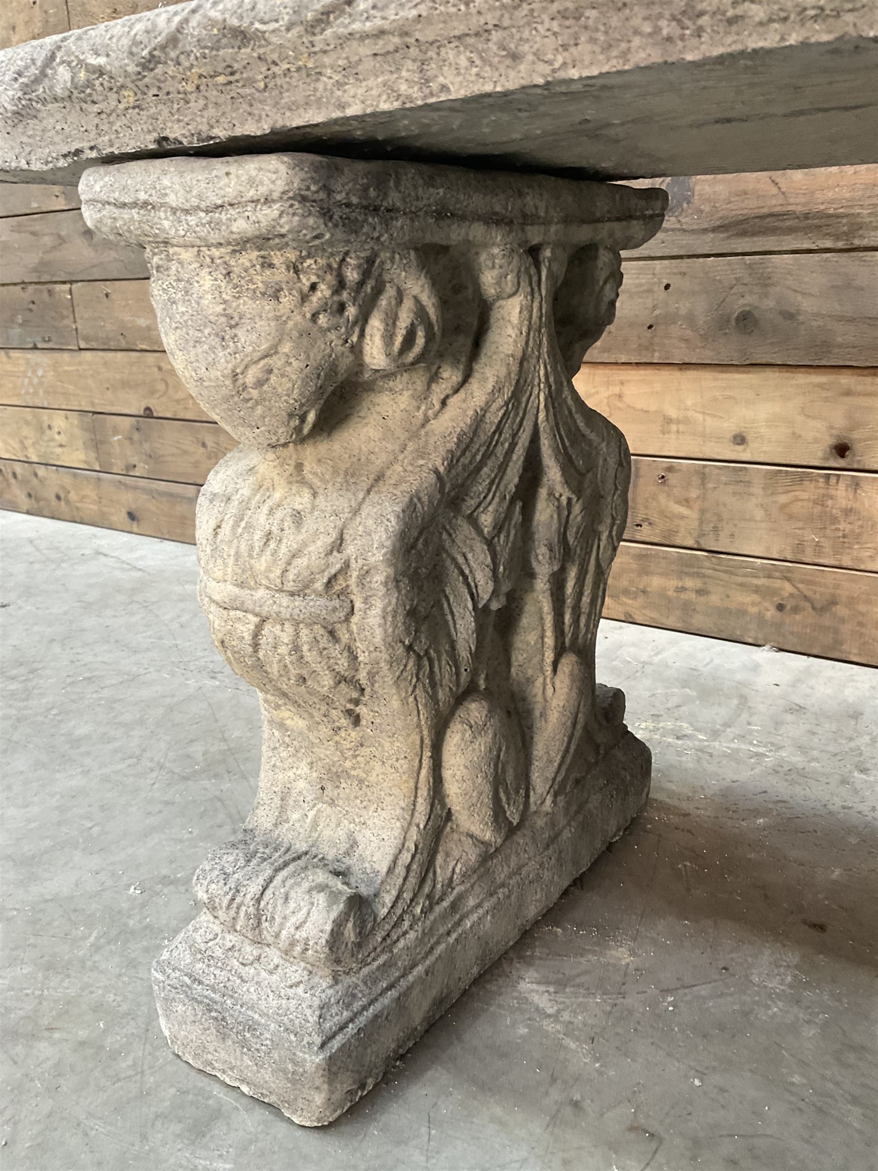 Cast stone garden Rams Head bench, two pillars set with architectural rams heads, rectangular slab seat