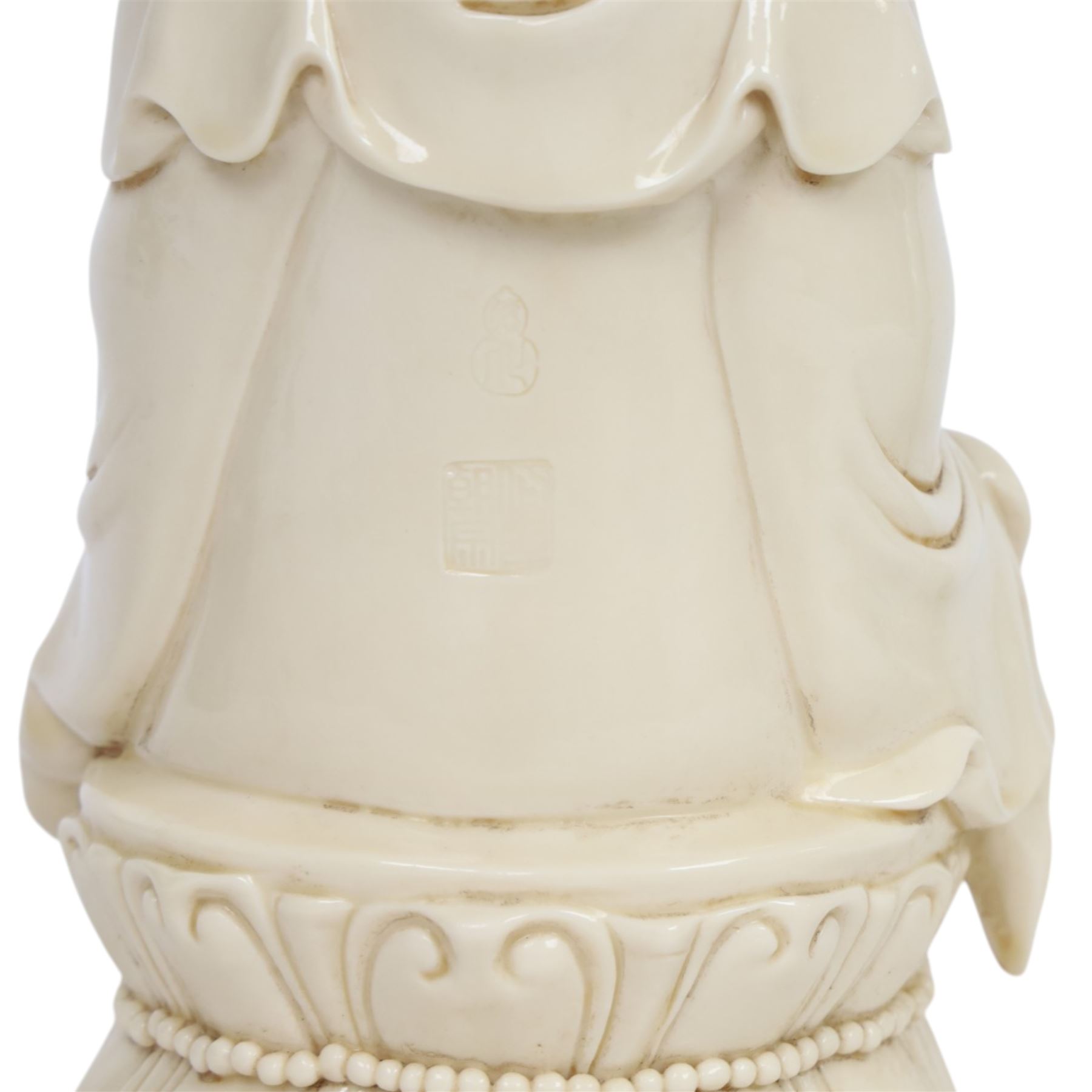 Three Chinese blanc de chine, each depicting Guanyin seated, Dehua province, two with double gourd and potters seal marks to the reverse 