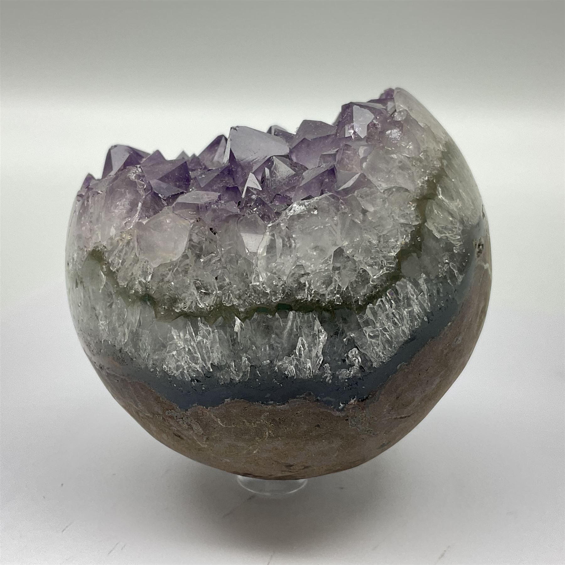 Pair of amethyst geode spheres, with purple crystalline internal formations, D9cm