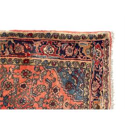 Persian Zanjan pale red ground rug, lozenge medallion and field decorated with floral Herati motifs, the border decorated with stylised plant motifs and trailing branches, floral pattern guard stripes