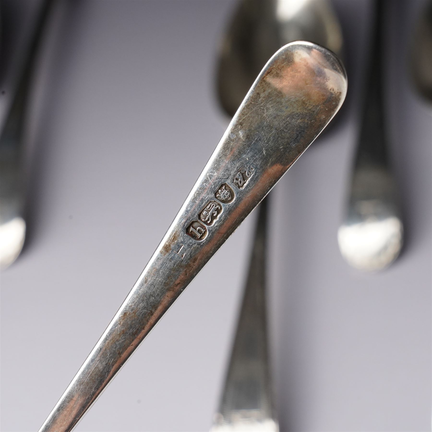 Set of six George III silver dessert spoons with bright cut stems and engraved with a crest London 1783 Maker Hester Bateman