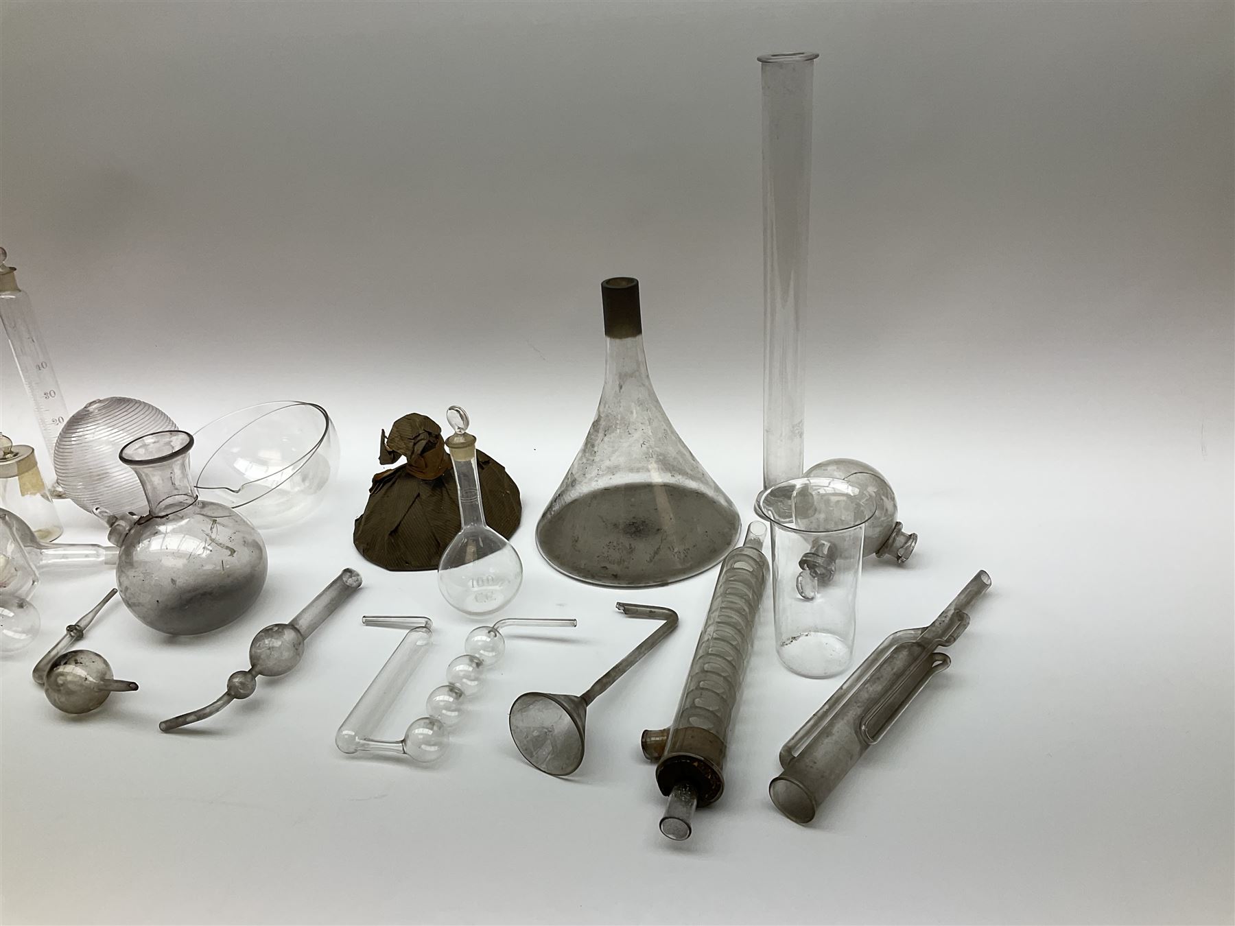 Collection of 19th century and later pharmaceutical laboratory glass, to include, volumetric flasks of various sizes, conical flask, stratus flask, etc (25) Provenance: discovered in the storeroom of a long established Hull pharmacist and opticians