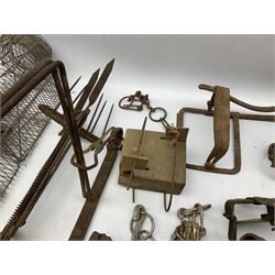 Quantity of animal traps including, gin traps, mole traps, Henri Marty wirework cage trap etc. Auctioneer's Note: These traps are sold as artefacts for ornamental purposes only as the use of some of them is illegal.