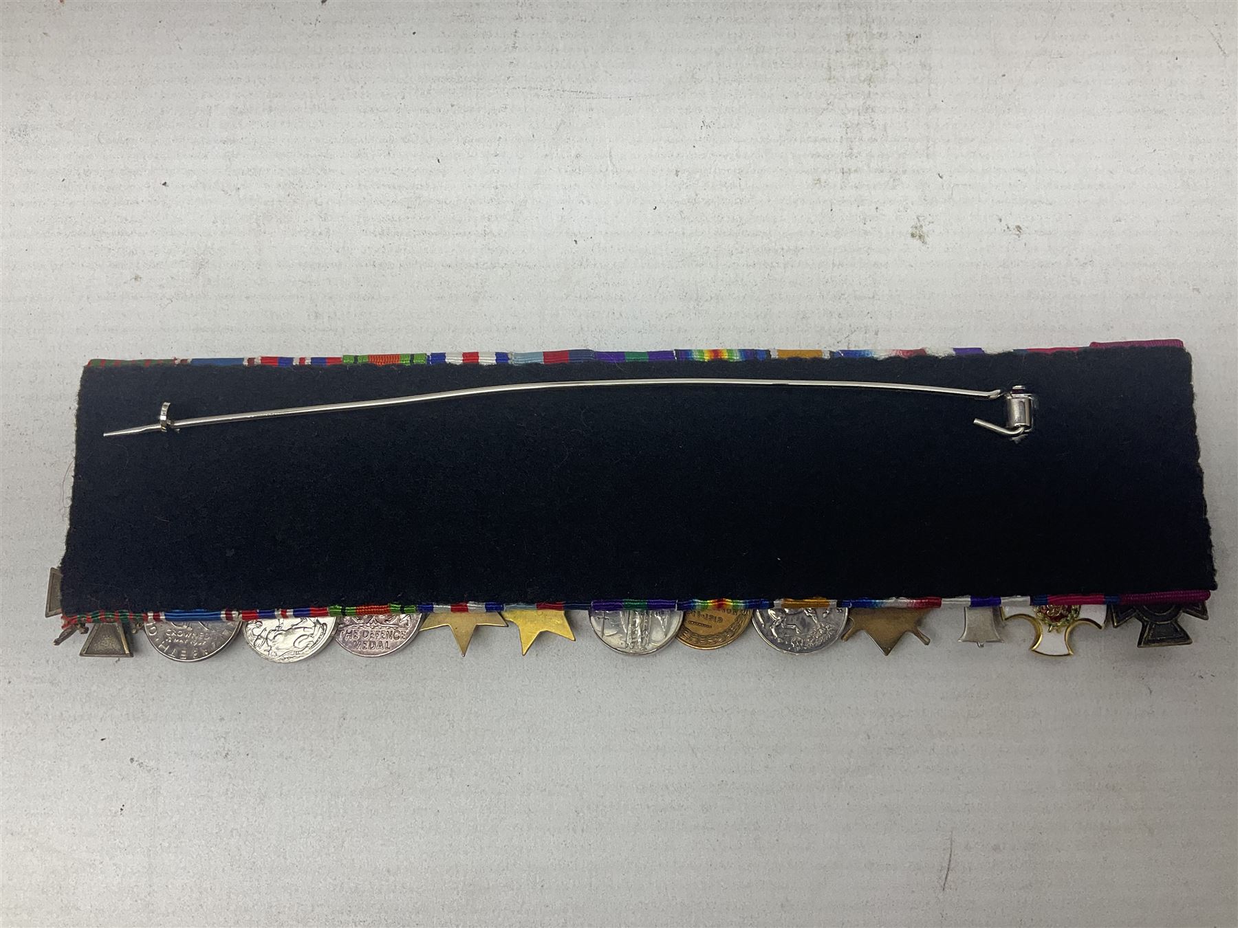 Captain (later Brigadier) Percy Howard Hansen V.C., D.S.O., M.C. 6th (Service) Battalion Lincolnshire Regiment - representative group of thirteen miniature dress medals comprising VC, DSO, MC, WW1 trio, GSM with Palestine clasp, four WW2 medals/stars, George VI Coronation Medal and French Croix-De-Guerre with MID leaves; all with ribbons on pinned bar for wearing; together with display of contemporary tunic ribbon bars for eight medals, framed with Lincolnshire Regiment cap badge, newspaper cutting and London Gazette extract; framed head and shoulder portrait of Hansen in uniform clearly showing his medal bars; and copies of related biographical information. Auctioneer's Note: Extract from the London Gazette 1st October 1915 regarding the VC 'For most conspicuous bravery on the 9th August 1915, at YILGHIN BURNU Gallipoli Peninsular. After the second capture of the 