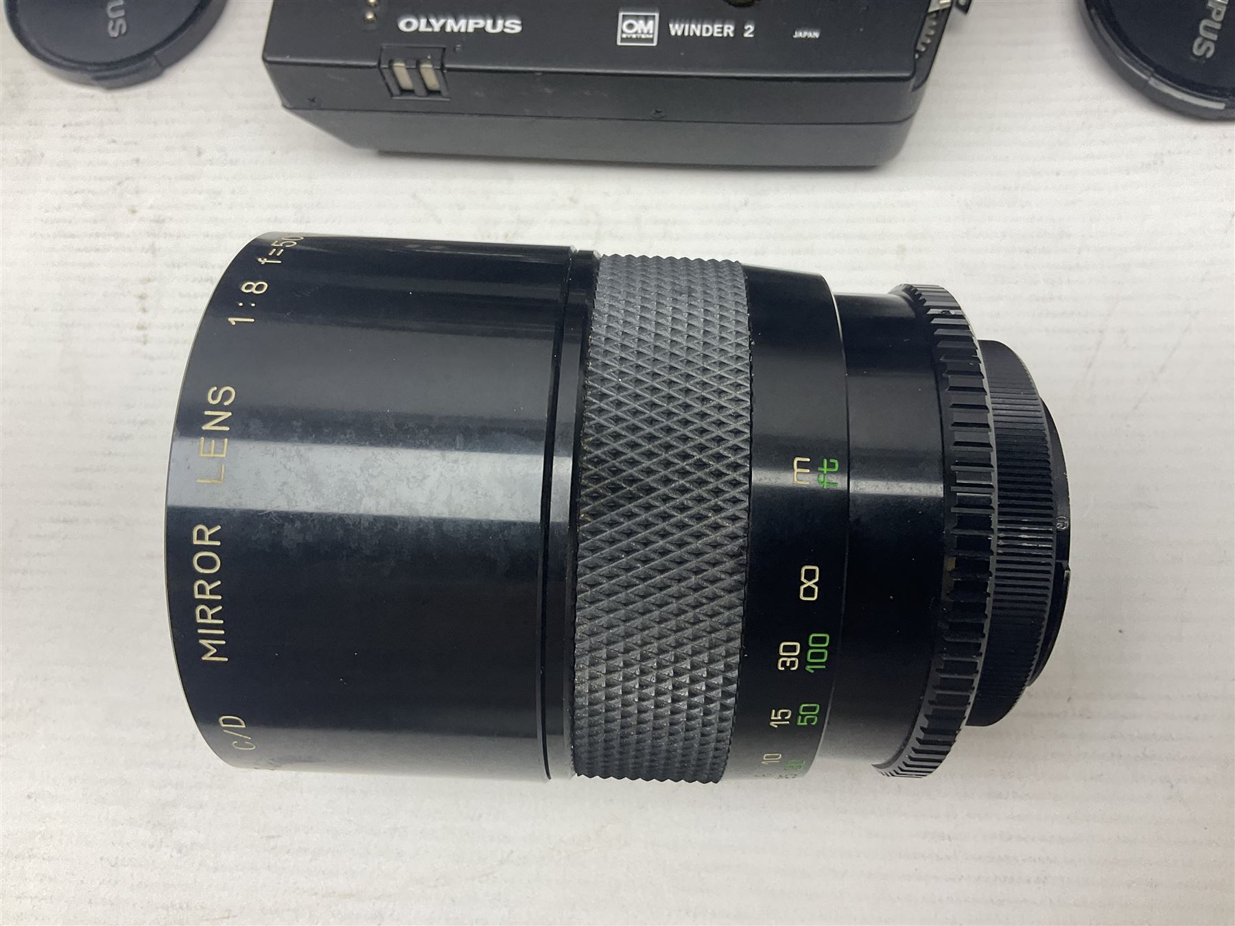 Olympus OM-2 camera body, serial no 1117526, with Olympus OM-System Zuiko Auto-W 28mm 1:2.8'  lens serial no 336591, Olympus OM10 camera body serial no 2392257, with Olympus OM-System Zuiko Auto-Macro 50mm 1:3.5' lens serial no 225784, Soligor C/D mirror lens 1:8 f=500mm' serial no 784035650 together with other camera equipment 