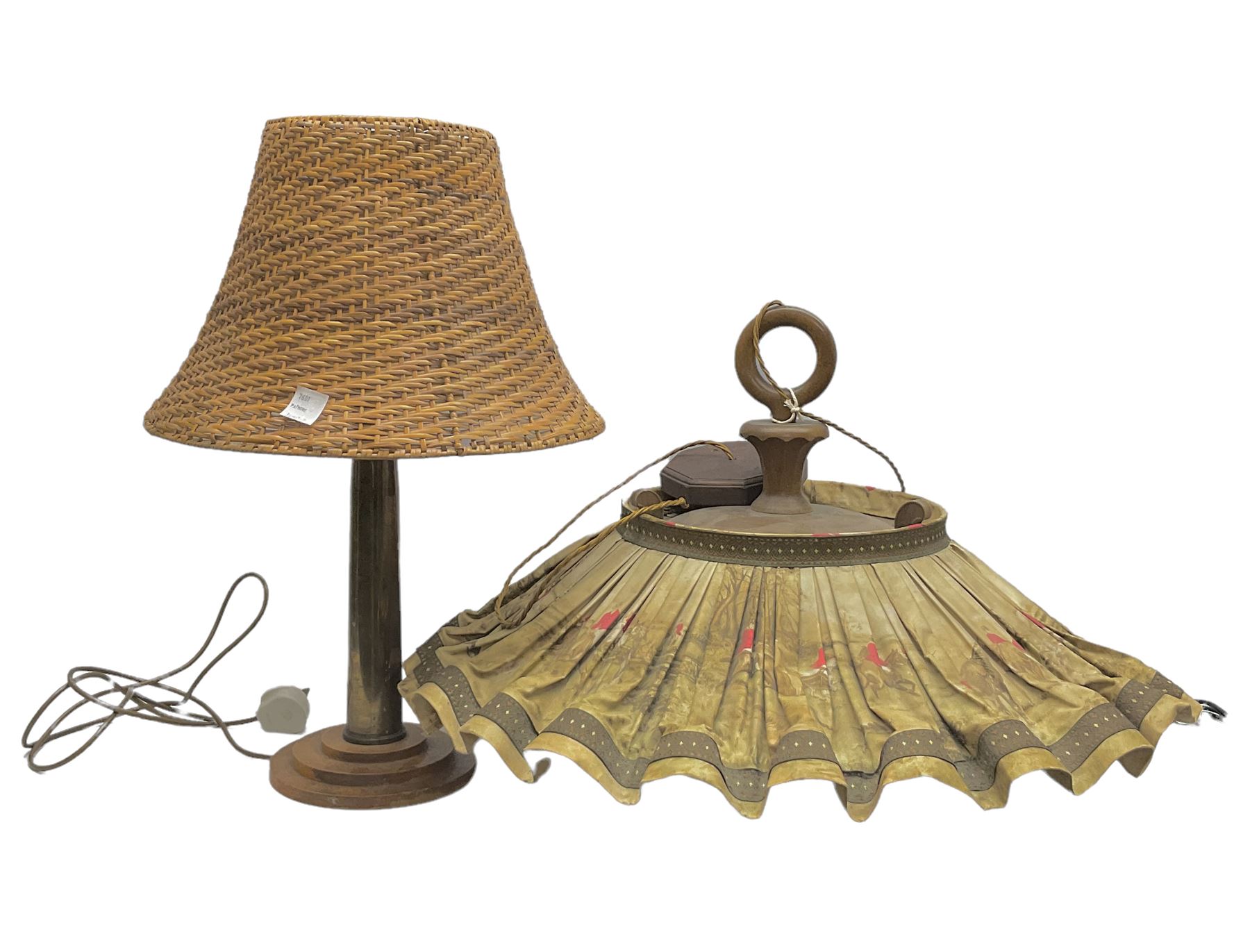 Trench Art shell lamp upon a stepped circular base, together light fitting with an umbrella shade depicting a hunting scene and a wicker lamp shade