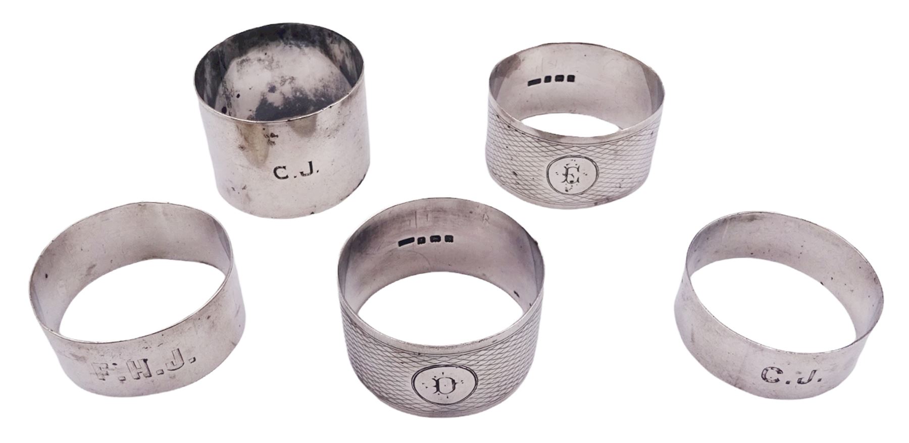 Five silver napkin rings, each of circular form, two examples with engine turned decoration, one Victorian example hallmarked Robert Thornton Birmingham 1869, a pair of Edwardian examples hallmarked T H Hazlewood & Co, Birmingham 1917, etc., approximate total weight 4.16 ozt (129.4 grams)

