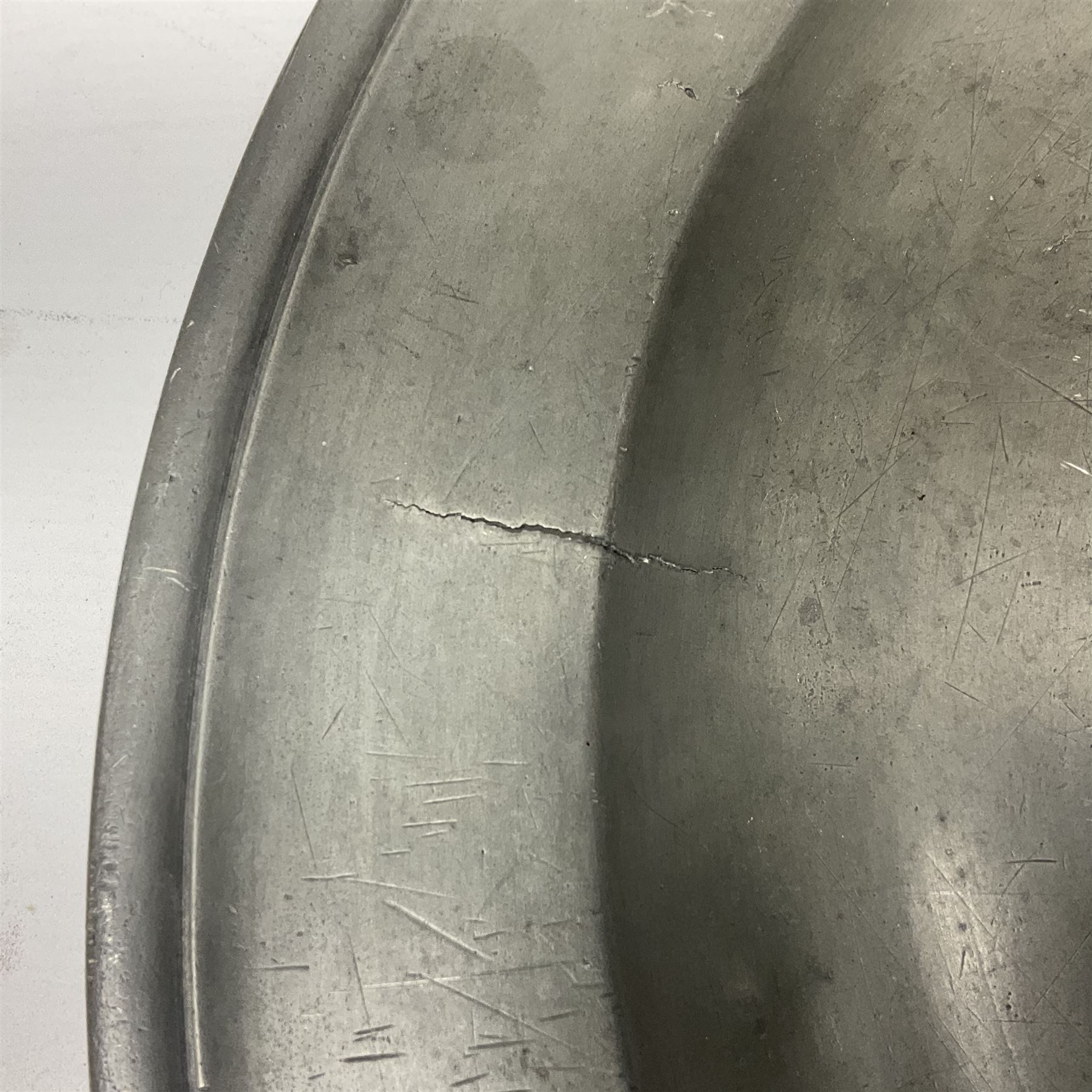 Group of seven 19th century pewter chargers, each of circular form with dished centre, two examples with touch marks verso, each approximately D39cm