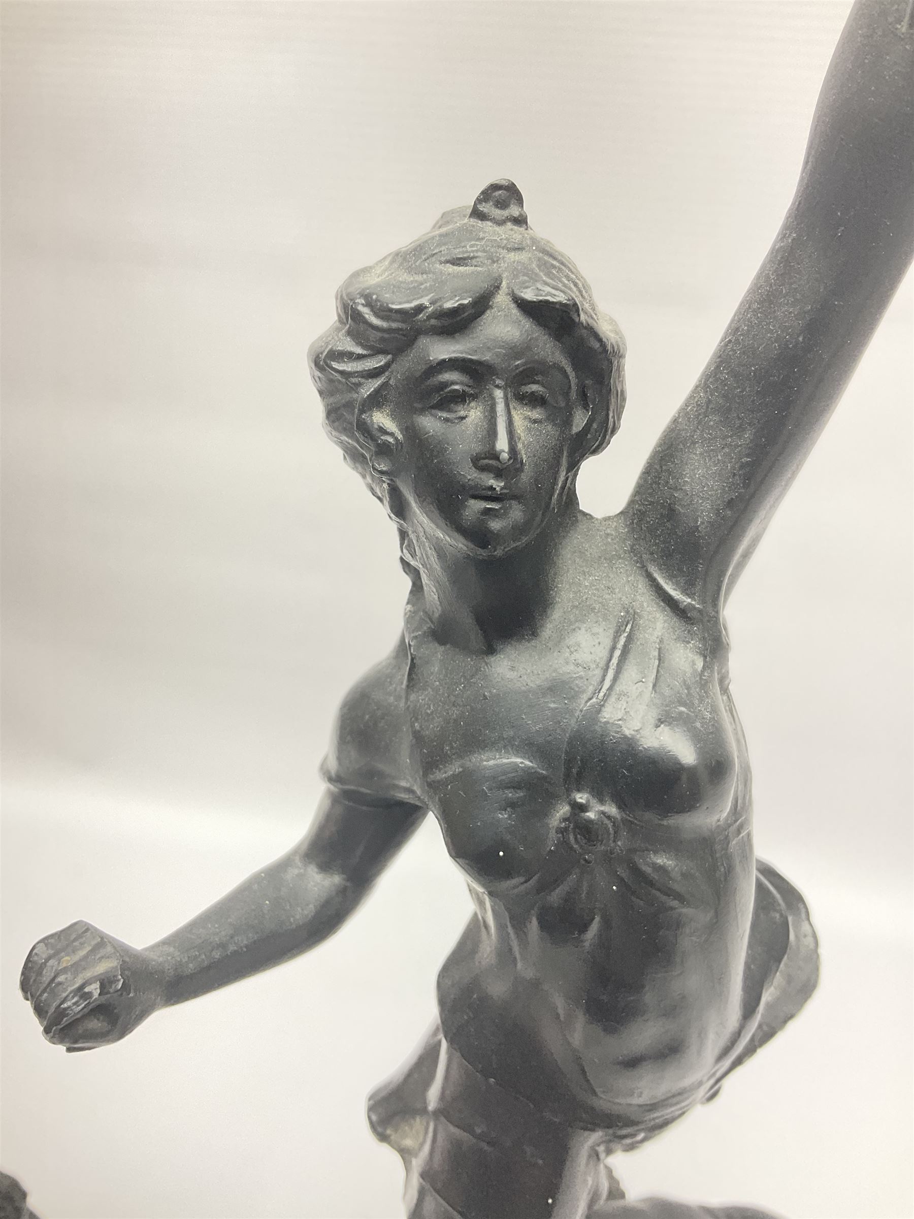 Pair of spelter figures, Le Force and Le Pouvoir, modeled as figures standing on lions, arms held aloft, H51cm 