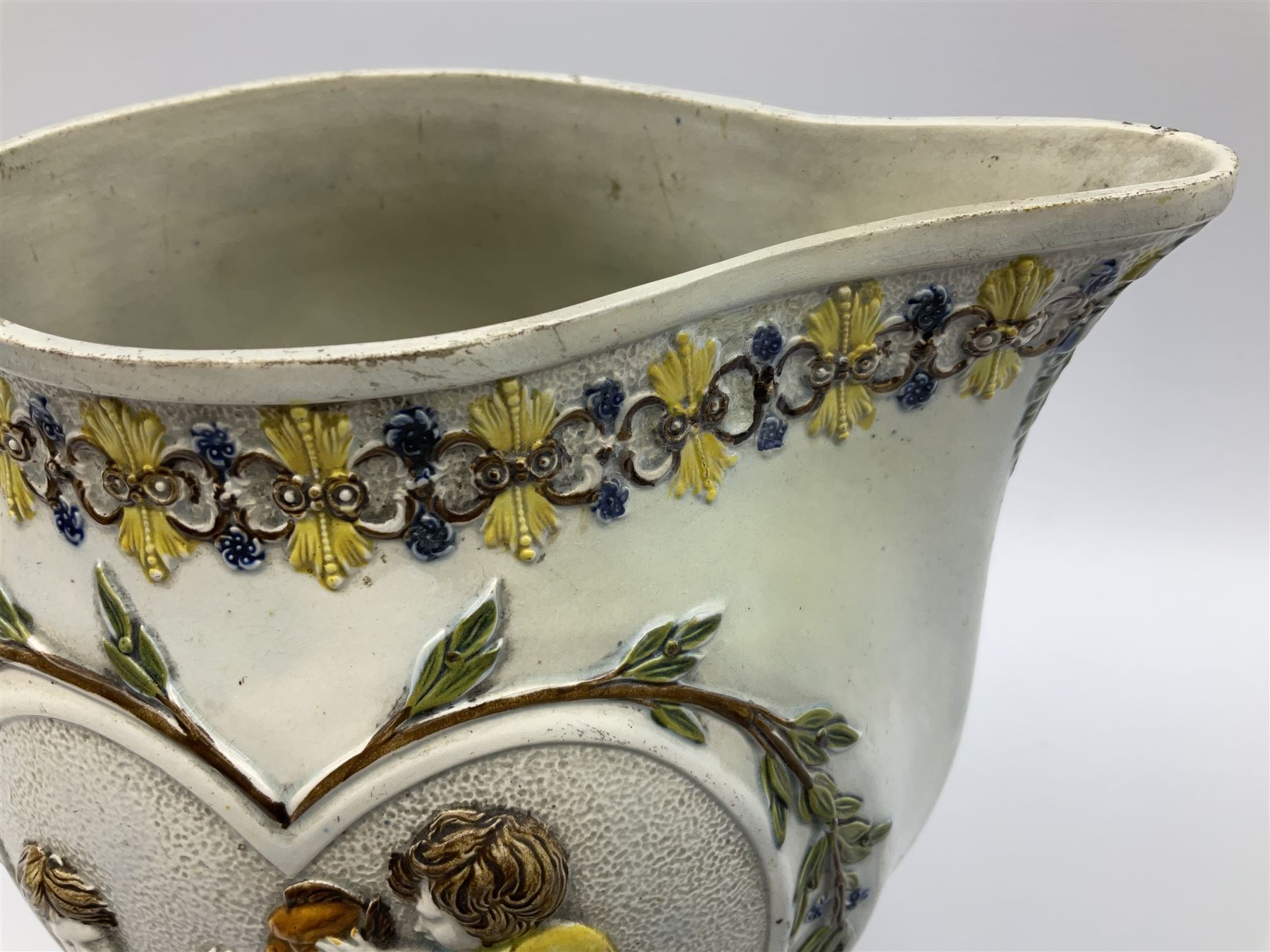 Early 19th century Prattware jug, circa 1800, decorated with two heart shaped panels of children, titled Sportive Innocence and Mischievous Sport, further decorated with acanthus and foliate borders, H22cm