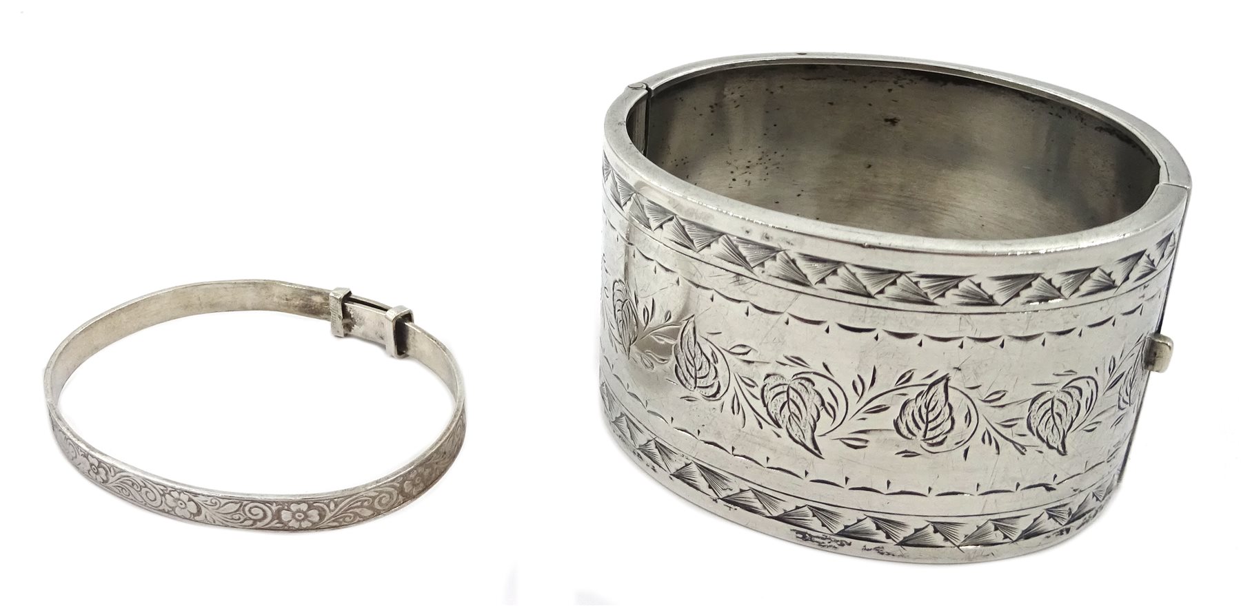 Silver bangle by Henry Griffith & Sons Ltd, Birmingham 1957, three other silver bangles stamped or hallmarked and a silver purse by Ellis Bros, stamped sterling