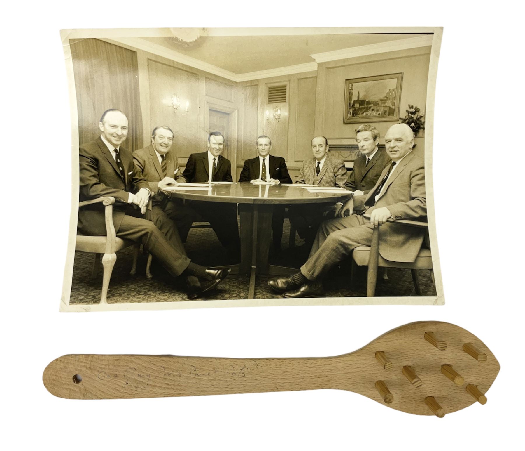 Early 1970s sepia photograph of the Pools Panel meeting at The Waldorf Hotel, London including Raich Carter, Marquis of Bath, Arthur Ellis, Neil Franklin etc 19 x 25cm; together with a beech spaghetti server with manuscript presentation inscription 'To Raich Carter from Henry 6th Marquis of Bath 1974'; Provenance: By direct descent from the family of Raich Carter having been consigned by his daughter Jane Carter (2)