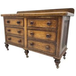 Victorian oak and sycamore dresser base, raised back over rectangular top with rounded front corners, fitted with six drawers with mahogany bandings and turned handles, on turned feet