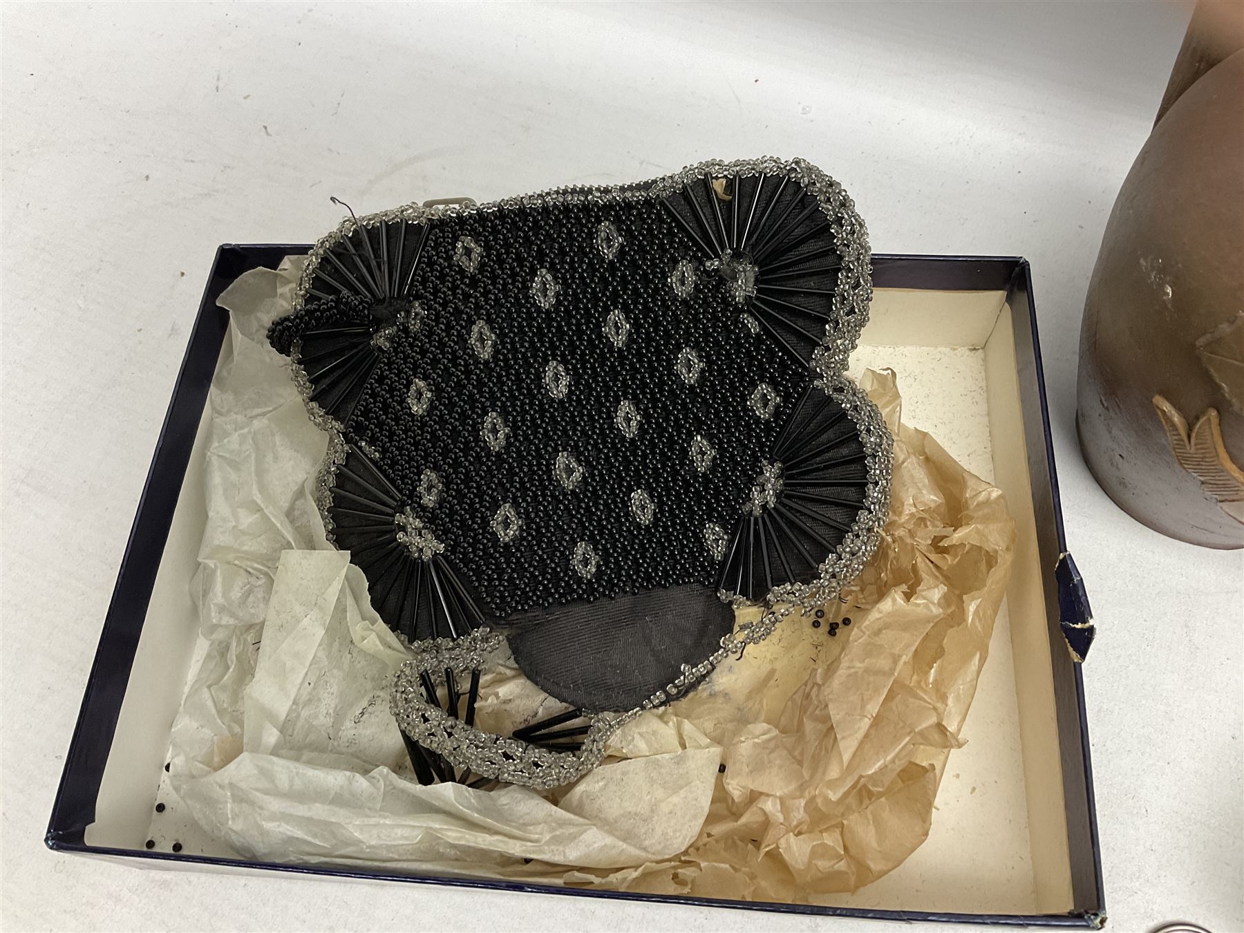 George V silver evening purse, the body of rectangular form with engraved decoration of swags and suspension chain, hallmarked G & C Ltd Birmingham 1918, together with Art Deco black beaded ladies bag (a/f), pair of hallmarked silver cufflinks, hallmarked silver bow brooch, 19th century portable inkwell, Victorian padlock stamped with the crown VR, etc