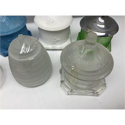 Collection of glass beehive honey pots, to include a blue slag example, milk glass, pink, green, etc together with four white metal examples (16) 