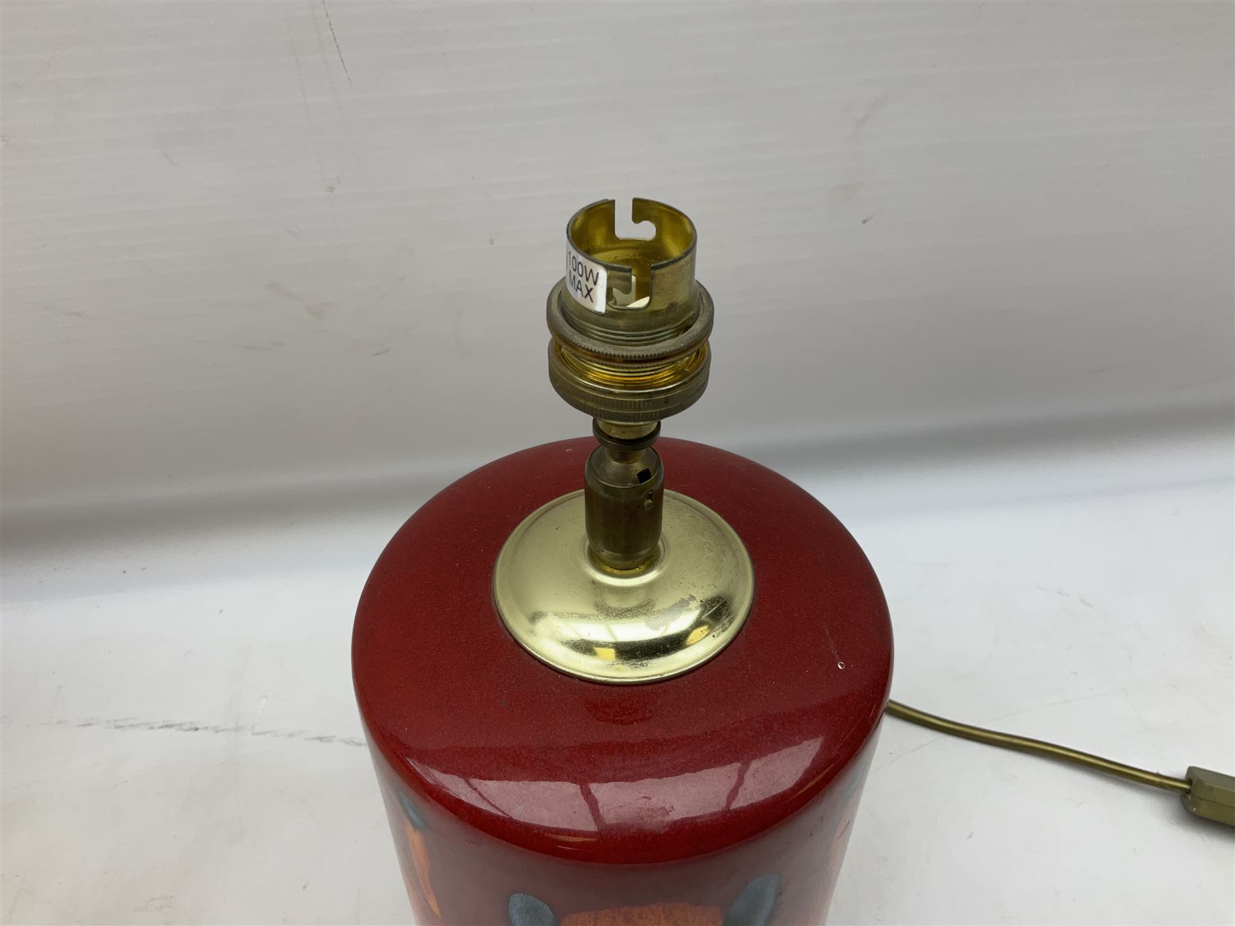 Poole Pottery table lamp in Volcano pattern of cylindrical form, with a cream lampshade, lamp H30cm