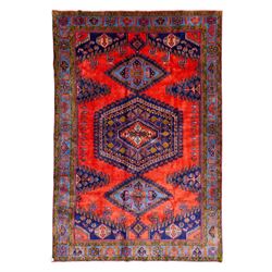 West Persian Veis hand-knotted rug, coral red field decorated with a series of bold geomet...