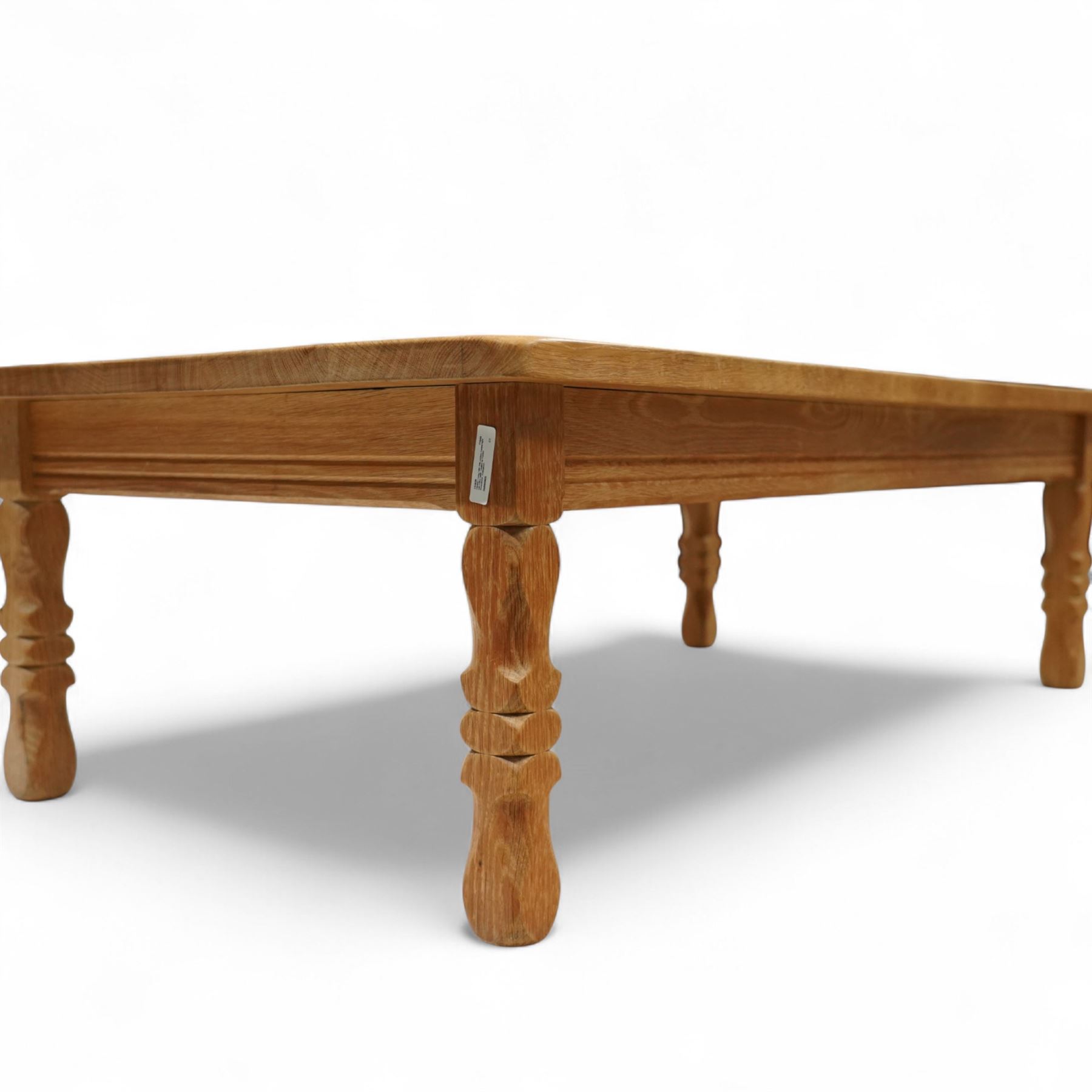 Mid-20th century light oak coffee table, retailed by Danish Homestores, Nottingham, rectangular top with prominent grain figuring, raised on turned supports