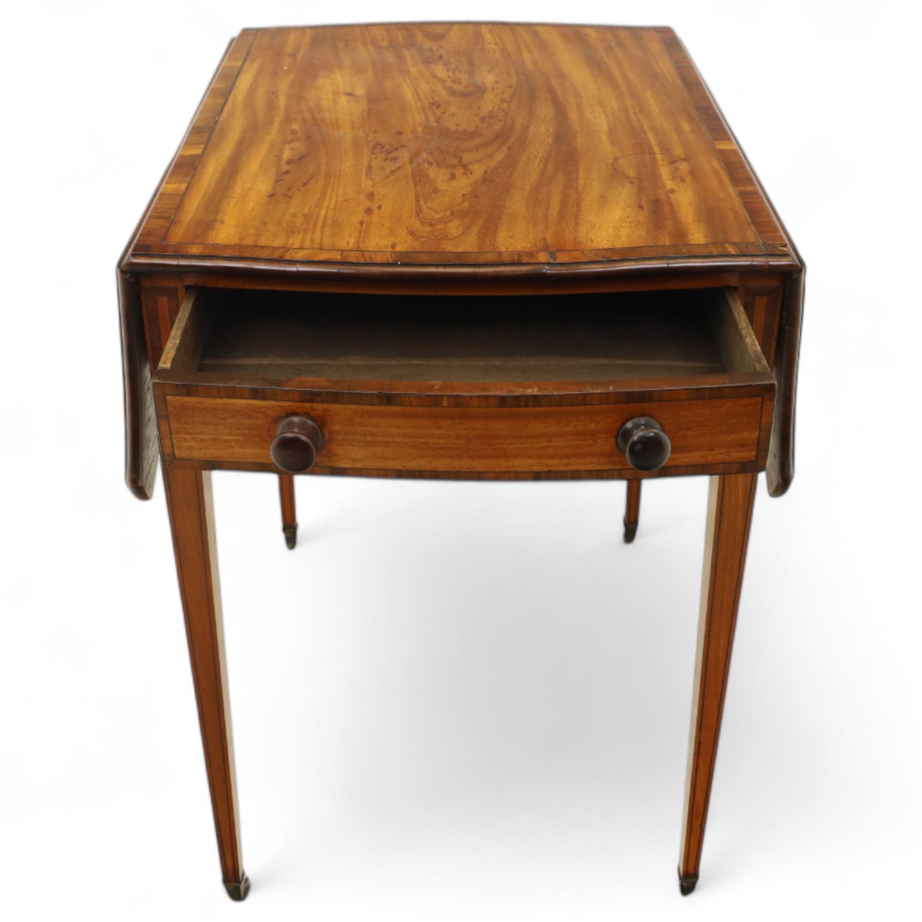 Goergian small butterfly pembroke table, the rectangular top with crossbanded edge and rounded drop leaves, single frieze drawer with opposing dummy drawer, raised on square tapering legs with stringing, terminating in brass castors