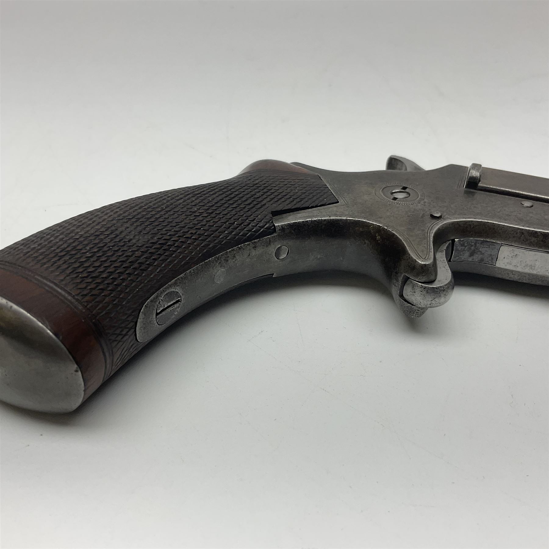 19th century .297/230 rimfire single shot break-action pistol, ''Tranter's Patent'', no.2;  the 25cm octagonal barrel marked Kynoch Gun Factory Aston; fin fore-sight, dove-tail standing notch rear-sight, open iron frame with barrel release button to the integral fore-end, central hammer, spur trigger and chequered walnut one-piece grip with domed iron pommel-cap L36cm overall