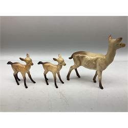 Collection of Beswick figures, comprising fallow deer family group, stag standing no.981, stag lying no.954, doe no.999a and two fawns no.1000b, together with badger family, boar no.3393, sow no.3394 and cub no.3392, all with printed mark beneath 