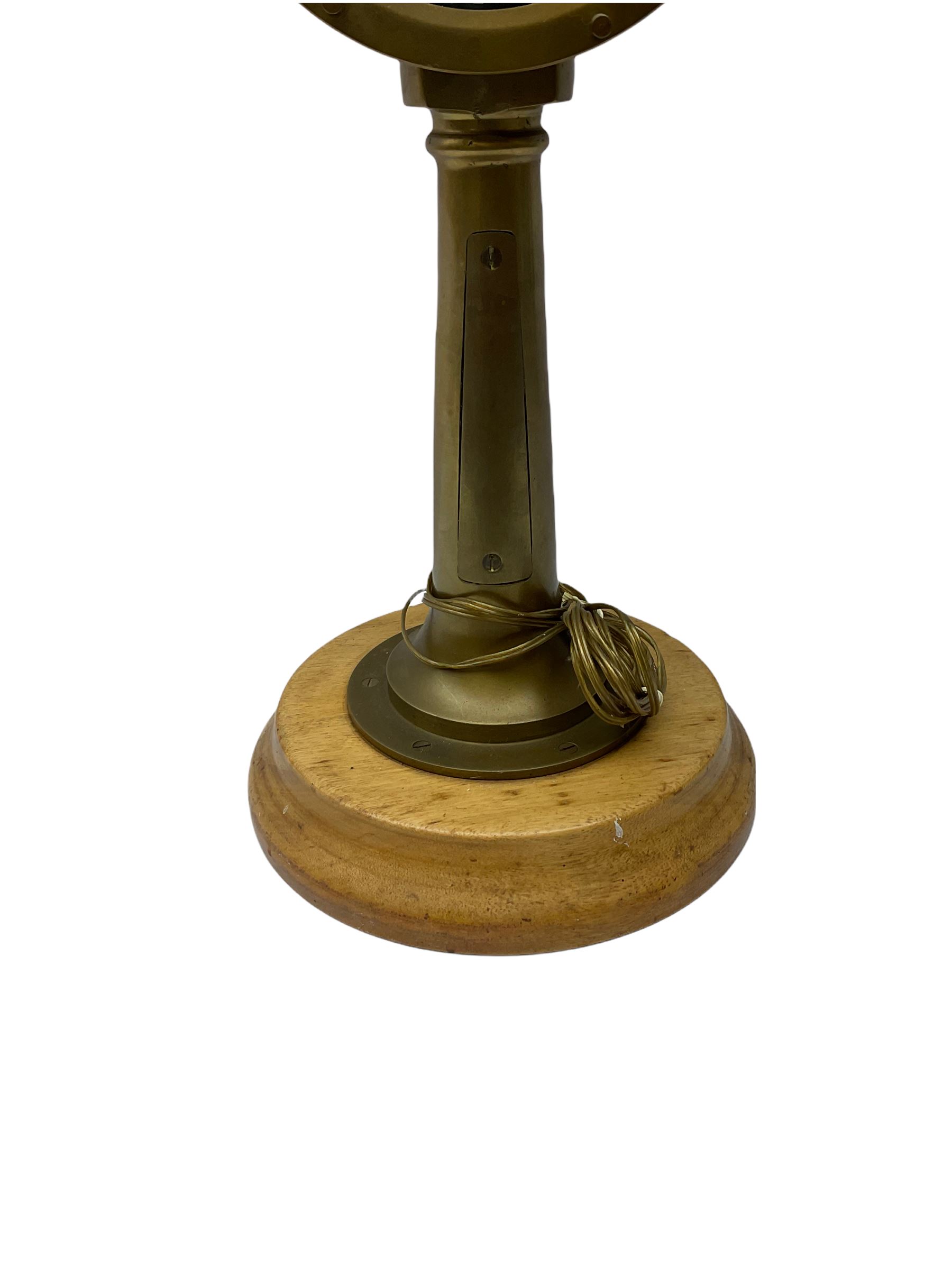 Early 20th century, illuminating brass ship's telegraph by Chadburns of Liverpool and London, on a circular wooden plinth, H55cm