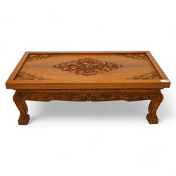 Hardwood rectangular coffee table, carved with trailing branches with foliage and flower heads, on scroll carved cabriole feet 