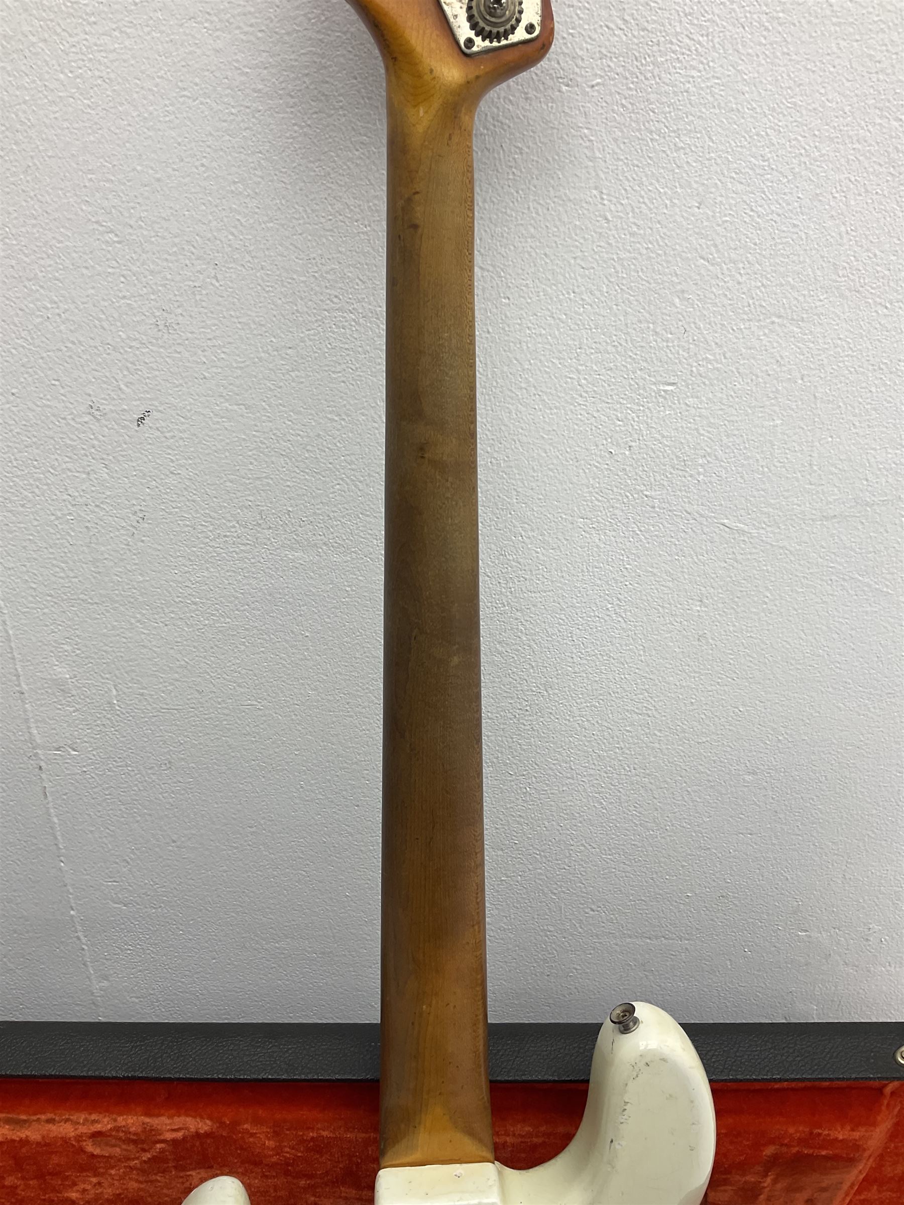 1963 Fender Jazz three-knob bass guitar; impressed with date code 7AUG63A on end of neck and serial no.L08587 on back plate; all original but re-finished in white in the 1970s; sold with photographs of the instrument in the 1960s with original finish and in the 1970s re-finished; L117.5cm; in original hard carrying case; Provenance: the professional guitar of Howard Livett from new to his death in 2005. Howard played in The Humperdincks, the backing group for Englebert Humperdinck, also played in the backing group for Max Bygraves and in the band Hedgehoppers Anonymous. The guitar is also sold with a manuscript letter of provenance from Howard's wife.