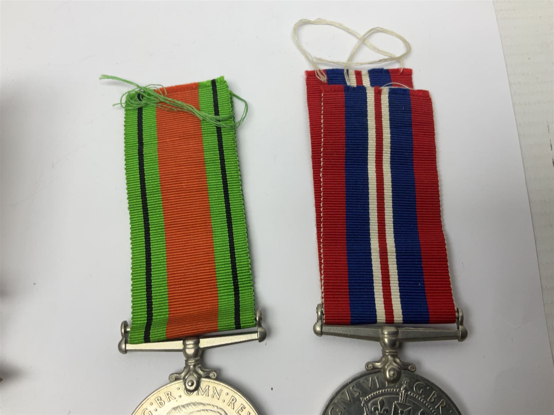 WWI pair of medals comprising British War Medal and Victory Medal awarded to 32682 Pte. W. Meadows W. Rid. R. in issue box; WWI pair of medals comprising 1914-15 Star and Victory Medal awarded to 3720 Pte. (later Cpl.) E. Petty W. York. R. with issue letter from Tank Corps; WWII group of five medals comprising 1939-45 War Medal, Defence Medal and 1939-45, Italy and Africa Stars; all with ribbons; and book of nineteen seaman's Certificates of Discharge to cook Charles Filburn 1893 - 1901 from various British ports
