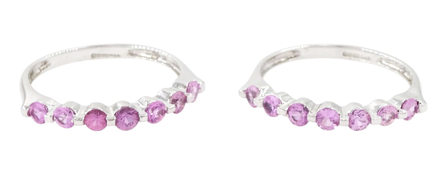 Two 9ct white gold pink sapphire half eternity rings, each set with seven round cut sapphires, both hallmarked Birmingham 2005, total sapphire weight approx 1.10 carat