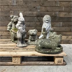 Various cast stone and composite garden ornaments, to include Peter Rabbit, goose, pigs, dogs, dog with wheelbarrow, painted metal bird bath and other, on two pallets