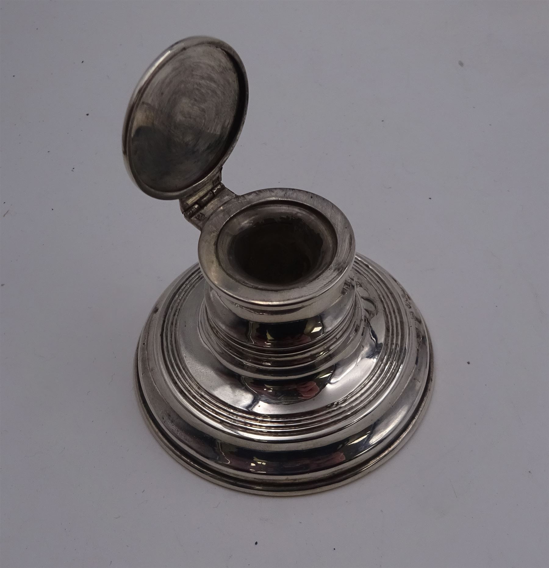 Group of early 20th century silver, to include a pair of specimen vases, of plain trumpet form, upon knopped stem and filled stepped circular foot, hallmarked J & R Griffin, Chester 1915, pair of silver mounted dwarf candlesticks, hallmarked J & R Griffin, Chester 1909, small silver mounted capstan inkwell with glass insert, hallmarked Chester 1909, maker's mark worn and indistinct, silver pepper, with pierced decoration, hallmarked S Blanckensee & Son Ltd, Birmingham 1909 and a similar mustard pot and cover, hallmarked S Blanckensee & Son Ltd, Chester 1909, both with blue glass liners