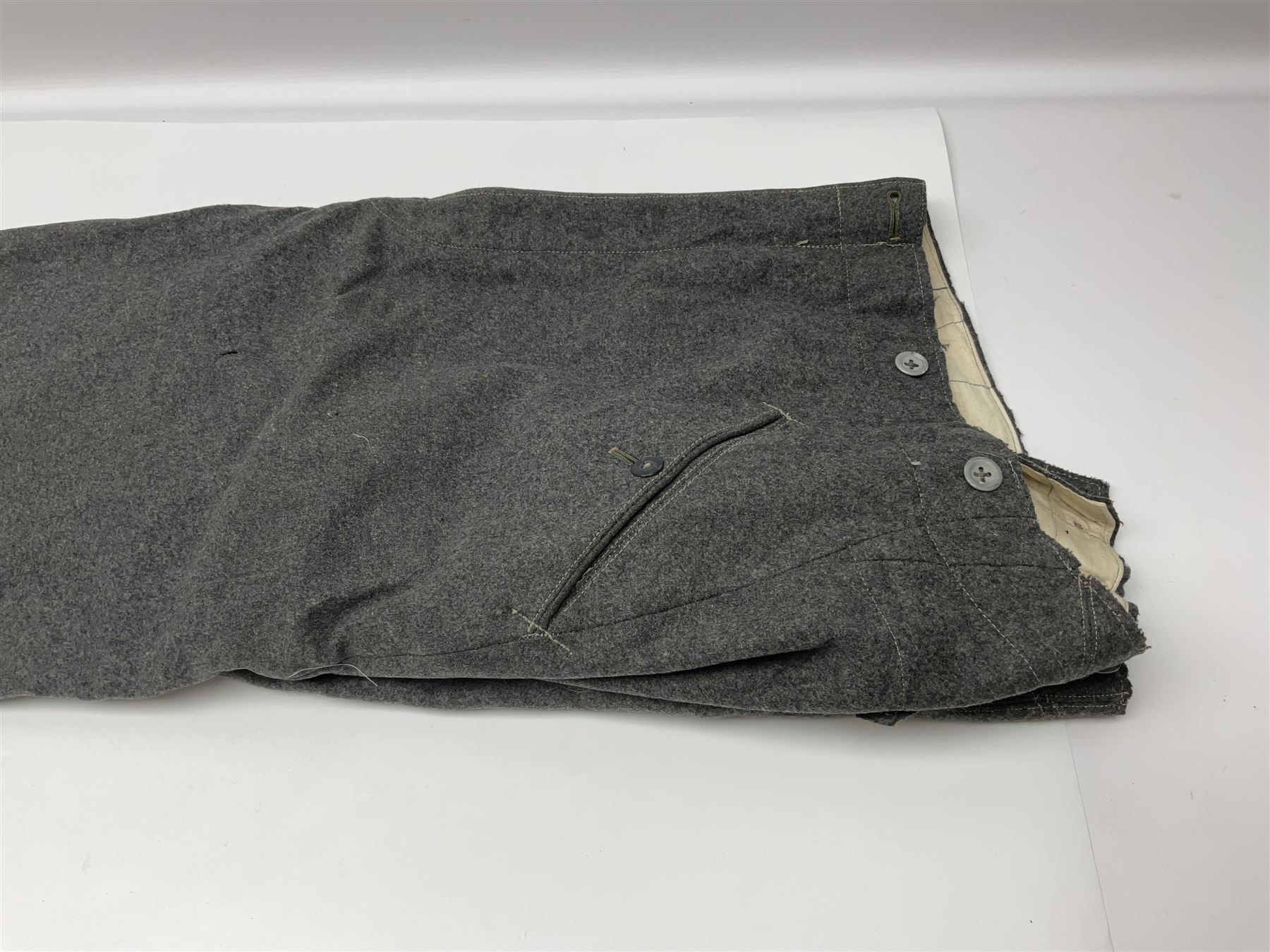 Pair of WW2 German Other Ranks trousers c1940-42, stamped C.& A. Brenninkmeyer Workstatten; WW2 German Army webbing belt with steel 'Gott Mit Uns' buckle; and WW2 German leather belt with 'Stahlhelm' (Steel Helmet League) members buckle (3)