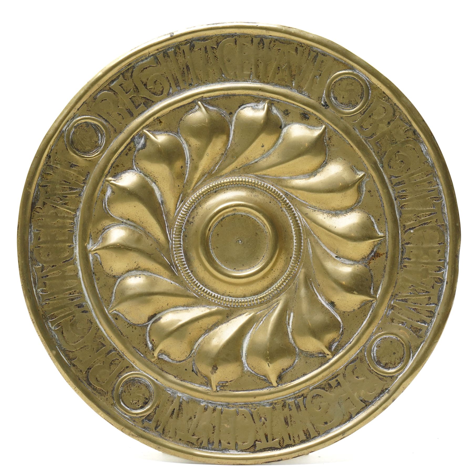 Central section of a 17th century Nuremberg brass alms dish, central rosette surrounded by Gothic inscription, intersected by roundels with engraved heads, D23cm 