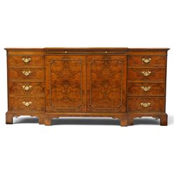 Georgian design figured and burr walnut breakfront sideboard, shaped rectangular top inlaid with crossbanding and stringing, fitted with central brushing slide over cupboard enclosing single adjustable shelf, flanked four graduating cock-beaded drawers to each side, raised on bracket feet