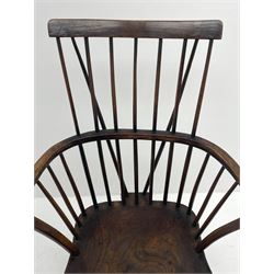 Early 19th century elm, beech and oak Windsor armchair, the plain cresting rail over low stick and hoop back, dished seat, turned supports joined by H stretcher 
