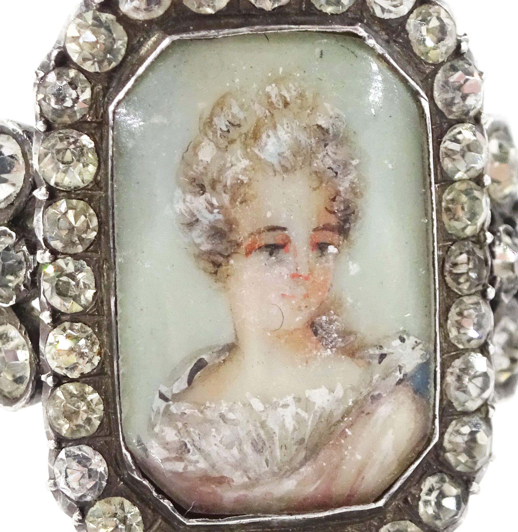 19th century 18ct gold and silver paste set portrait ring, octagonal miniature of a woman on ivory, under a glazed panel, with paste stone surround, to bifurcated paste set shoulders. This lot has been registered for sale under Section 10 of the APHA Ivory Act