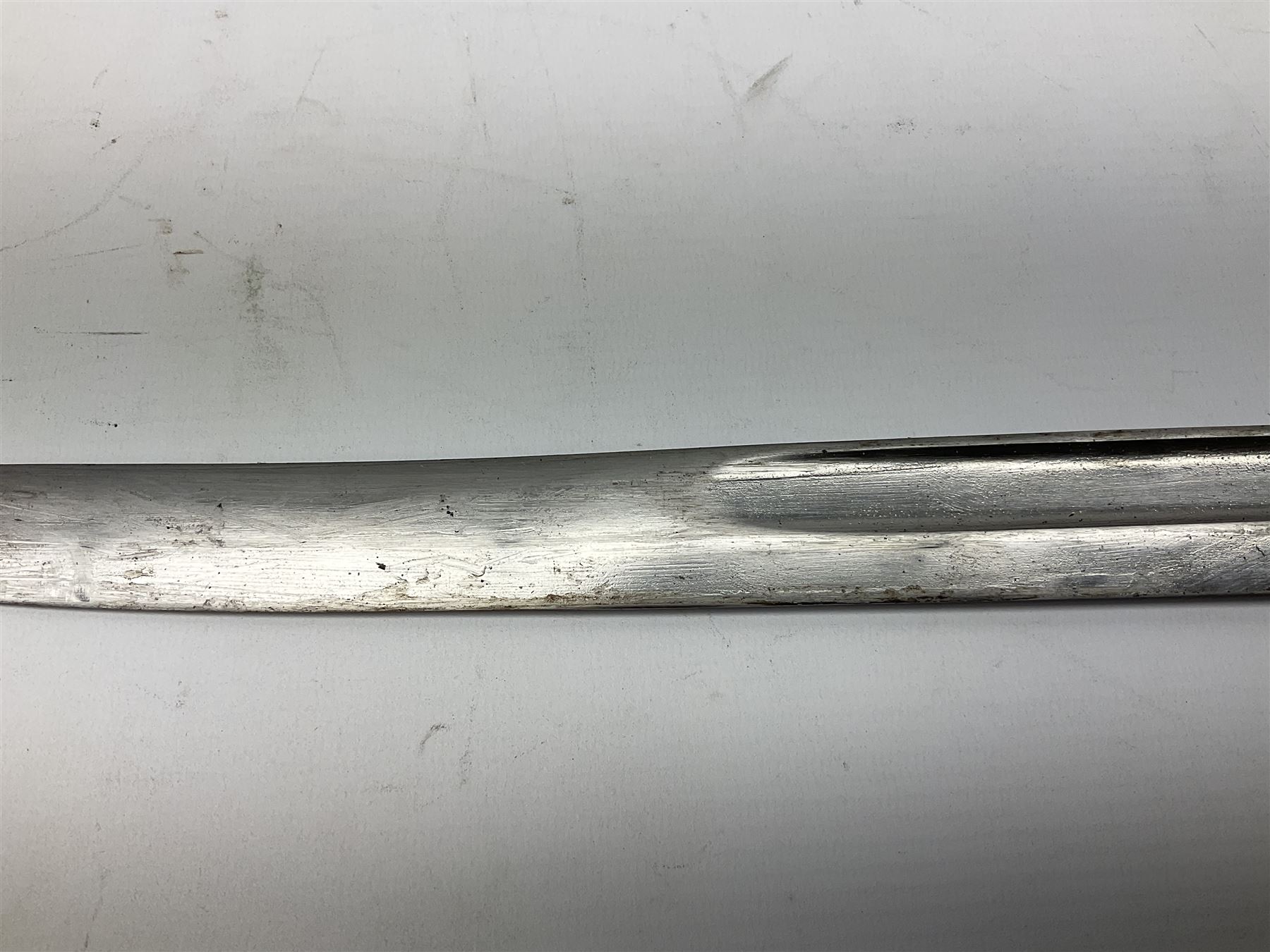 Turkish Model 1874 sword bayonet with 57.5cm curving steel fullered blade and chequered black grip, in steel mounted leather scabbard L75.5cm overall