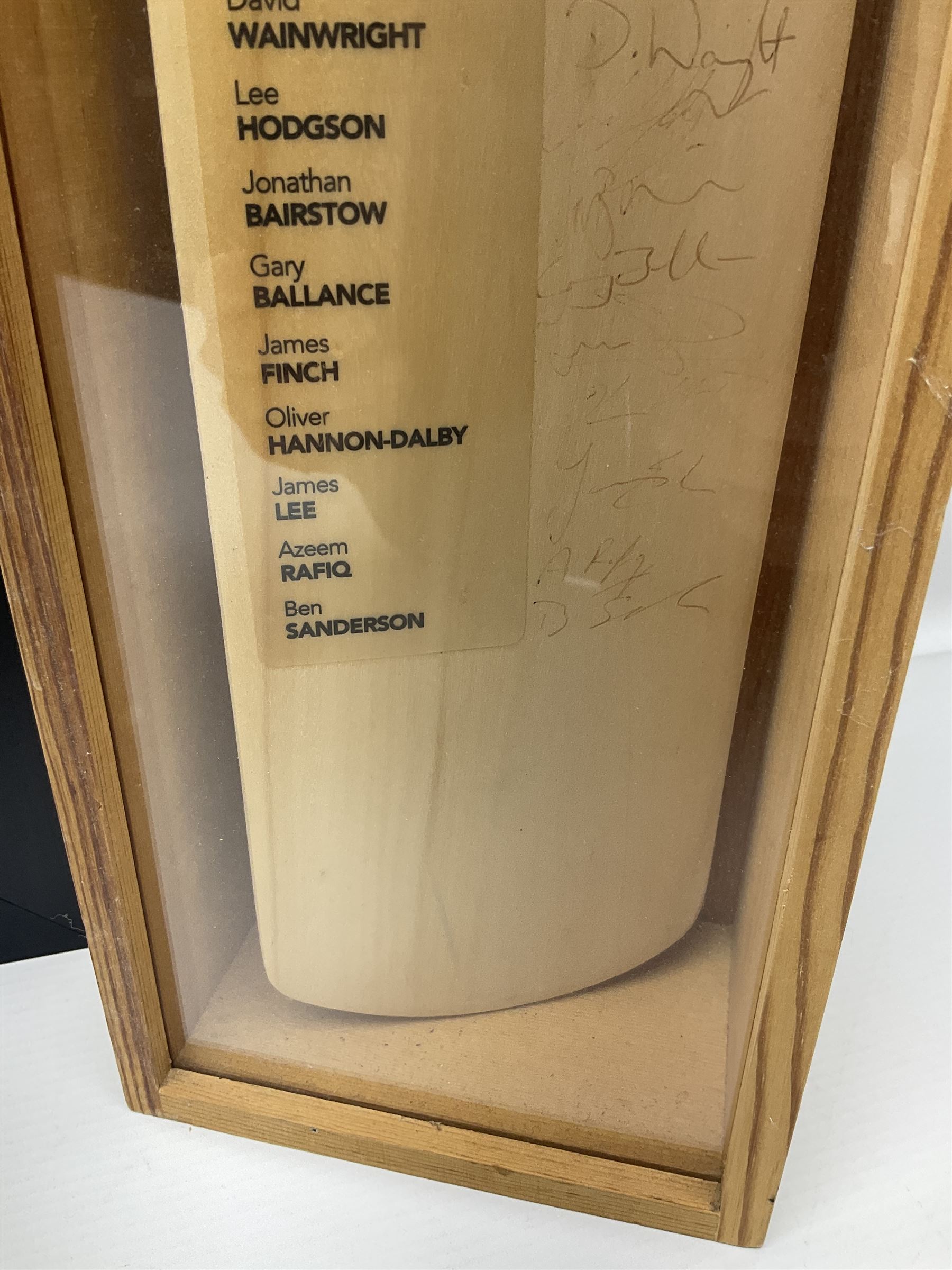 Two signed Yorkshire County cricket bats, bearing signatures including Anthony McGrath, Jacques Rudolph, Michael Vaughn and Matthew Hoggard, etc, both within glazed presentation boxes, box H86.5cm, together with a framed Darren Gough signed presentation print by Gary Keane