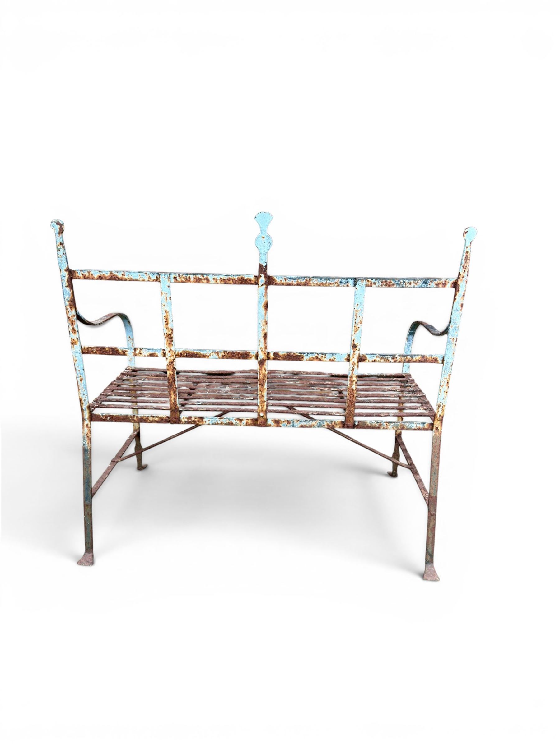 Regency period wrought iron strapwork garden bench, cresting rail with central Scottish thistle motif and flanking pediments, in distressed blue painted finish