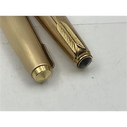 Three rolled gold Parker fountain pens, comprising an example with a gold nib marked 14K 585 and barrel with a shell stamp, a Parker 61 fountain pen with inset gold arrow to the nib, and another similar, all with striated decoration and arrow clips to the caps, L13cm, one with box