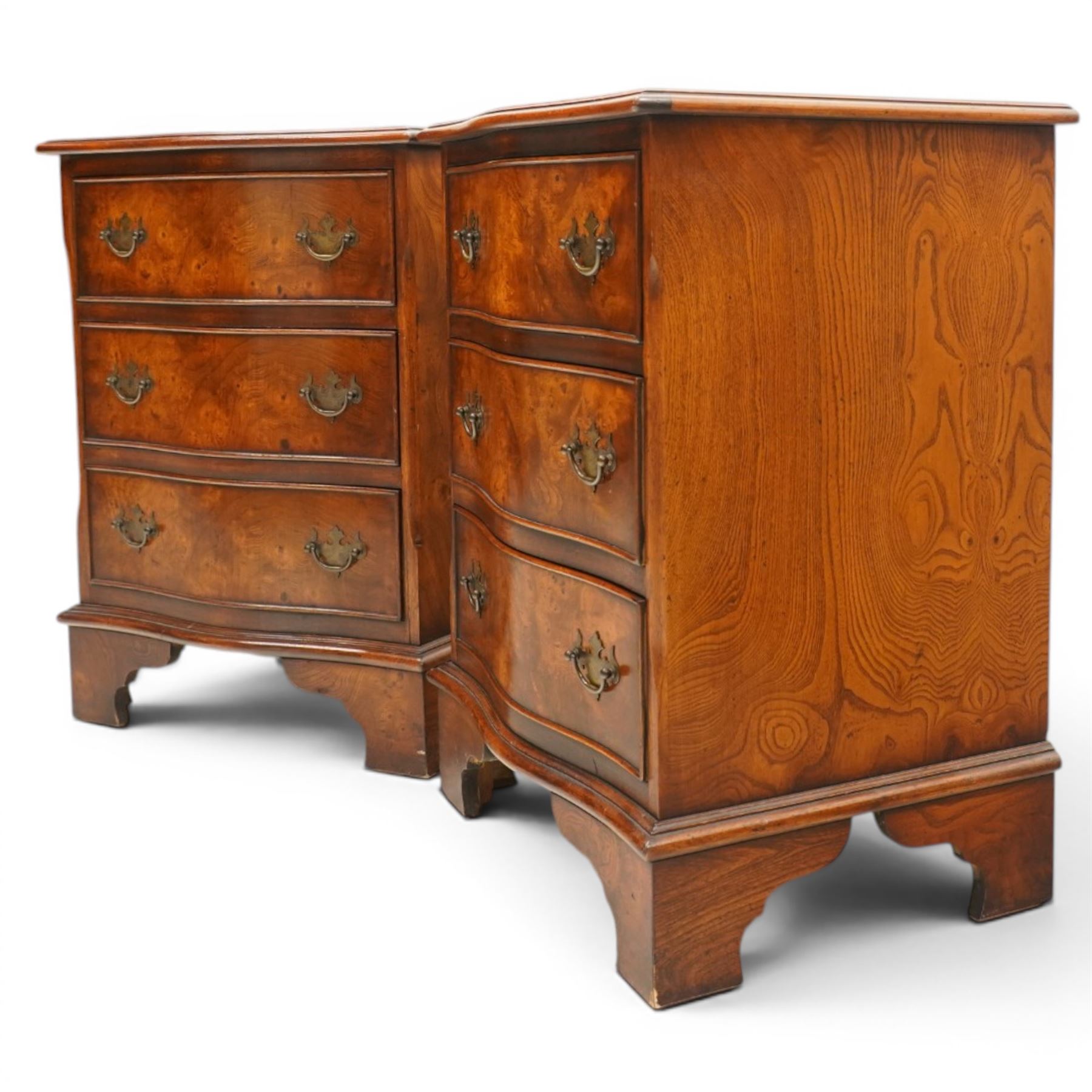Pair of Georgian design figured elm serpentine bedside chests, moulded top raised on bracket feet